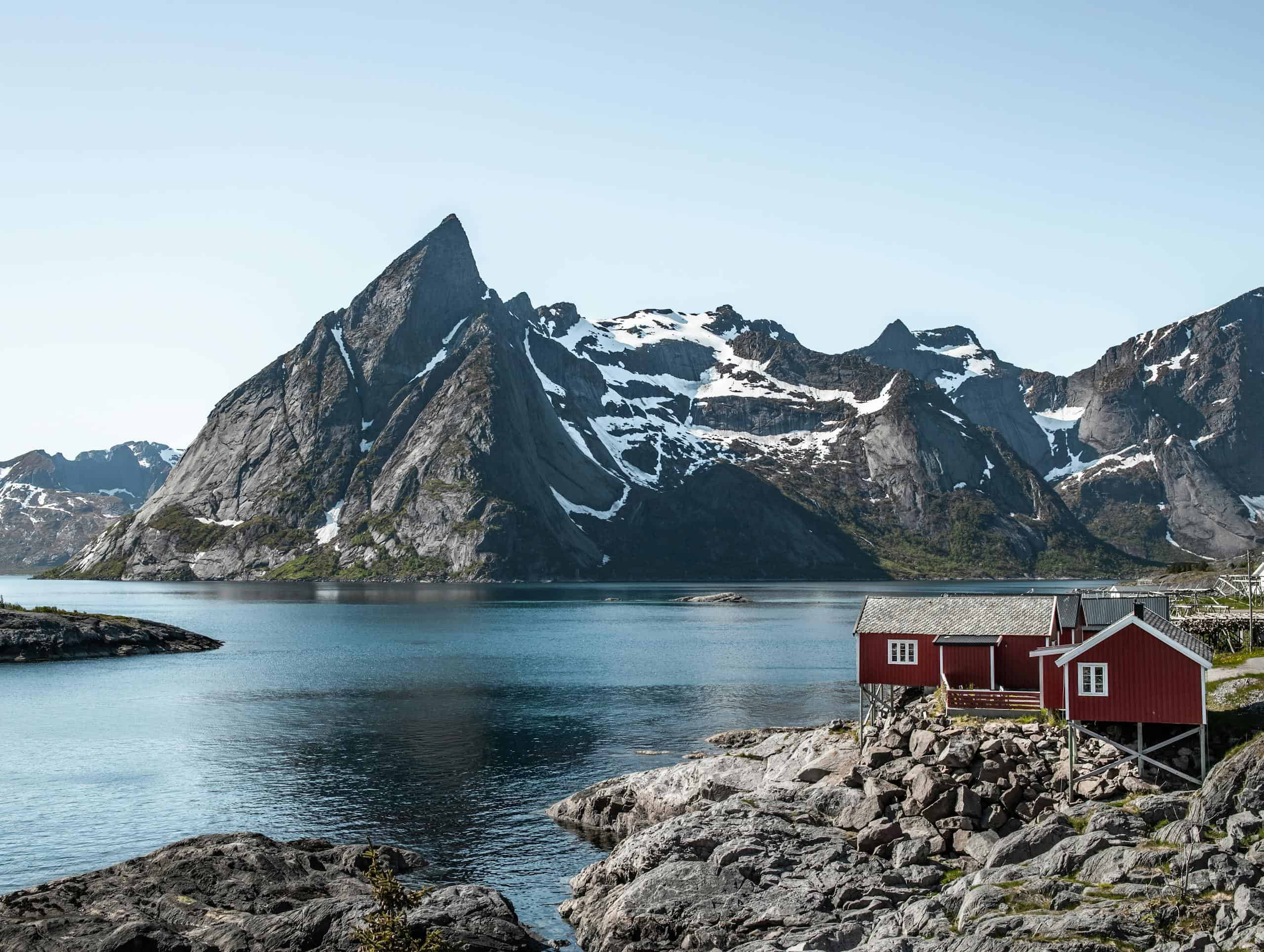 Red and White House Near Body of Water and Mountain